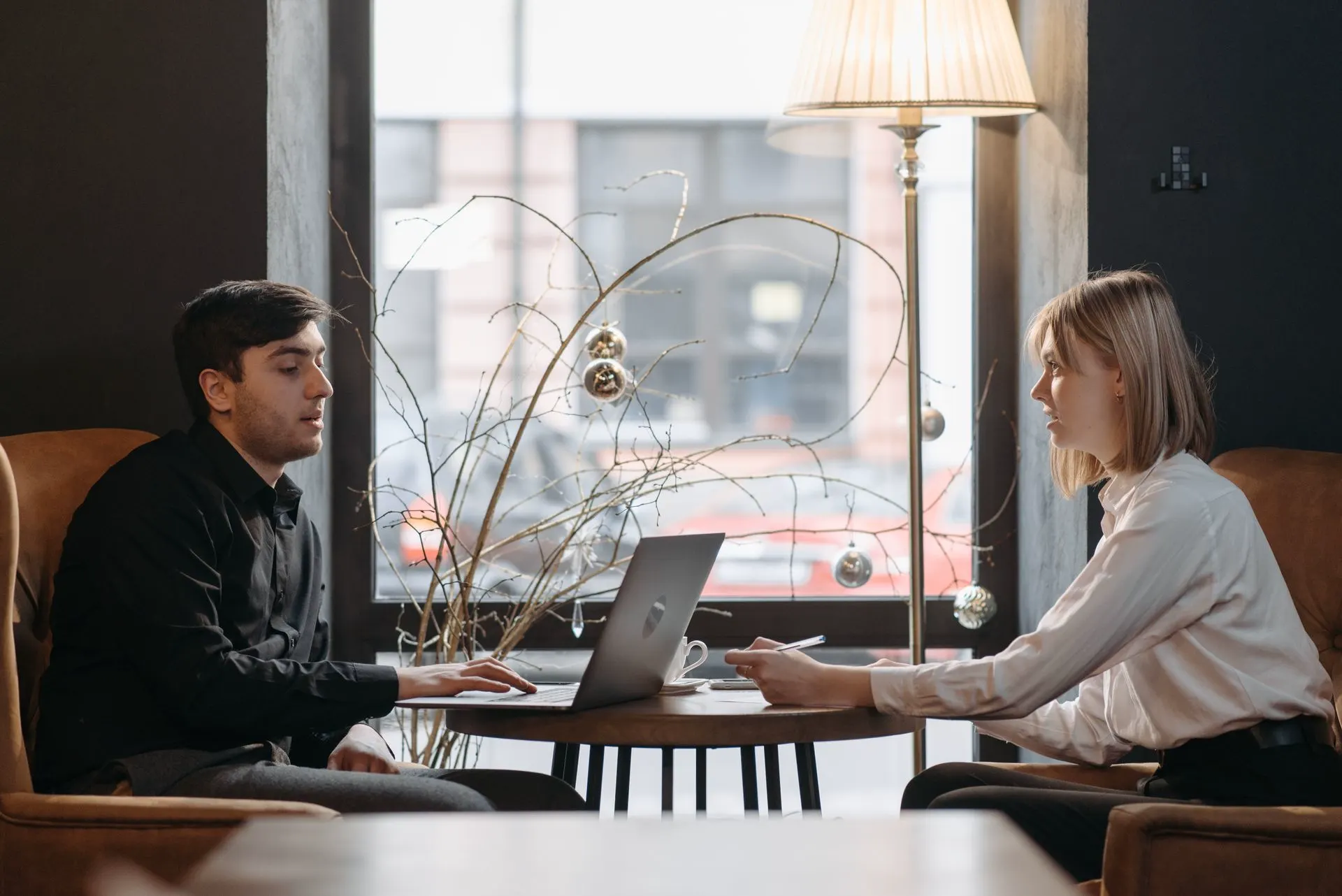 A consultant walking a business owner through options on a laptop